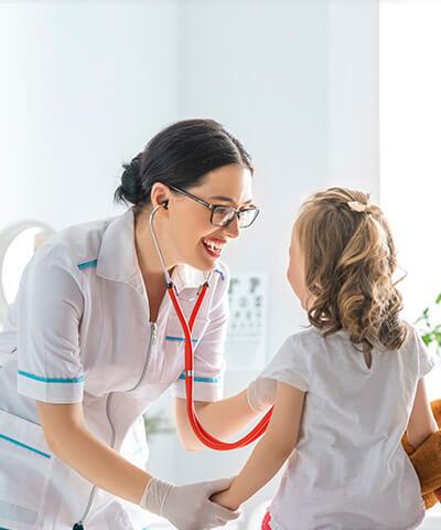 Seguro de Salud - Doctora examinando a una niña en el hospital médico